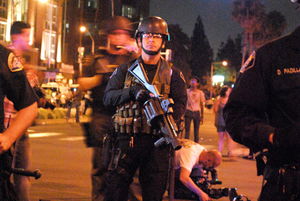 A police officer prepares to break up a protest in downtown Anaheim in July 2012. (Photo: Nick Gerda/Voice of OC)