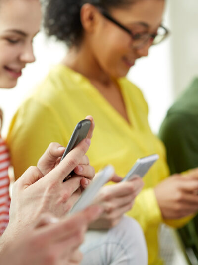 young people looking at their mobile devices