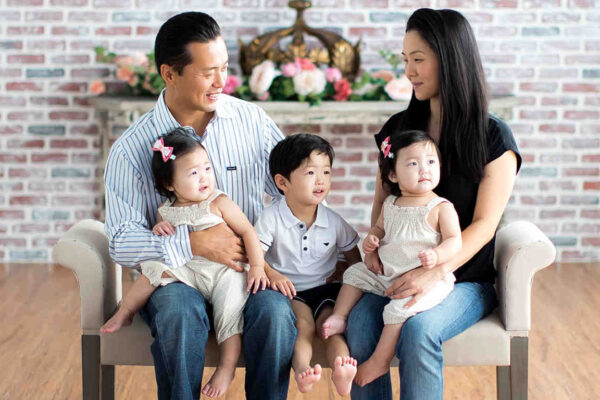 Mark Hwang with his wife, young son, and young twin daughters