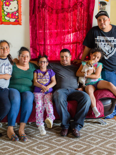 Jesus Arreola with his family sitting on a couch