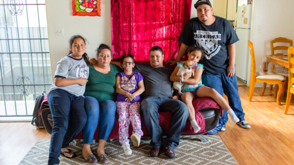 Jesus Arreola with his family sitting on a couch