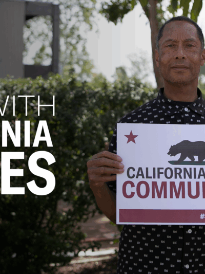 Stand with California Values. Man holding sign that reads: California Values Communities