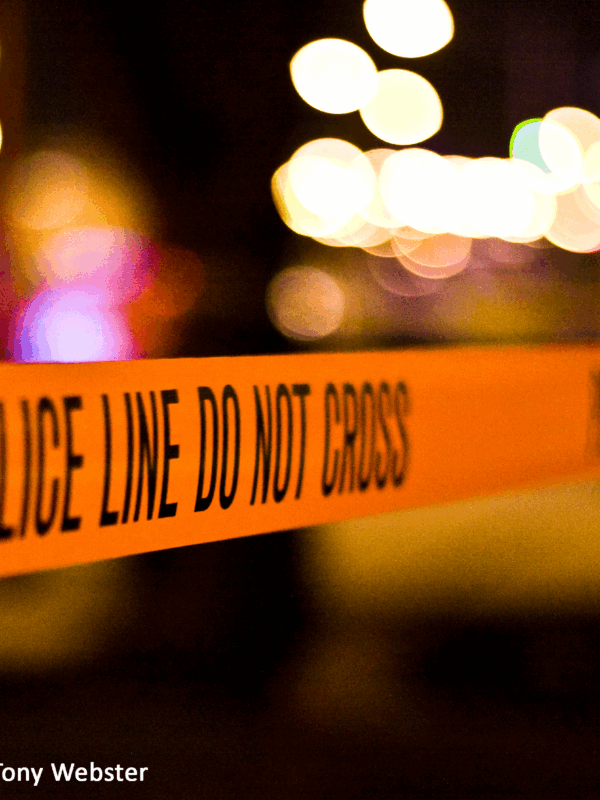 Orange tape with text that reads: Police line do not cross