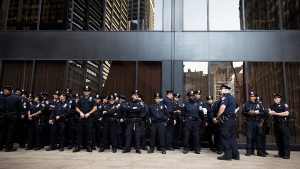 A large group of police officers standing in front of a building