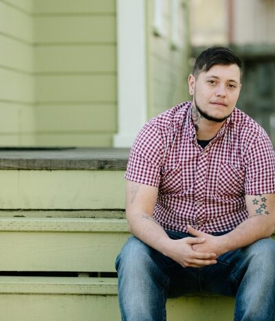 Oliver Knight sitting on the steps of a porch
