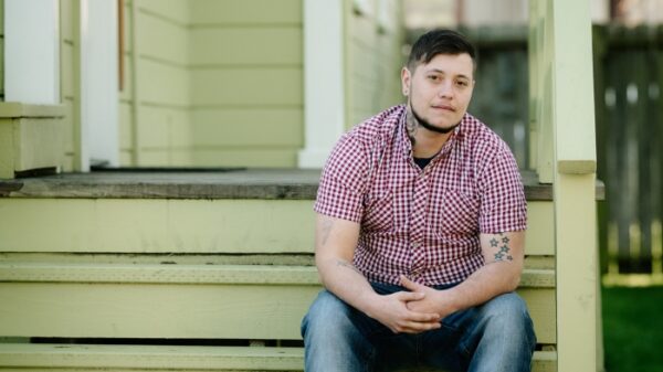 Oliver Knight sitting on the steps of a porch