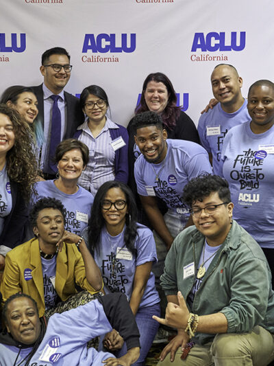 A group of people at ACLU CA's 2018 Conference and Lobby Day posing in front of an ACLU backdrop