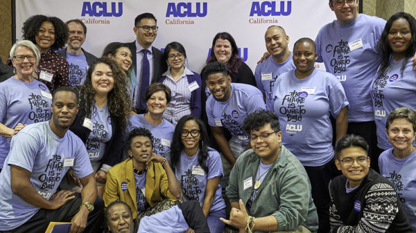 A group of people at ACLU CA's 2018 Conference and Lobby Day posing in front of an ACLU backdrop