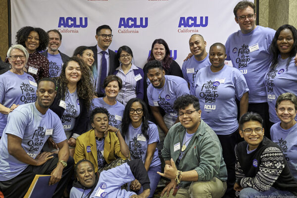 A group of people at ACLU CA's 2018 Conference and Lobby Day posing in front of an ACLU backdrop