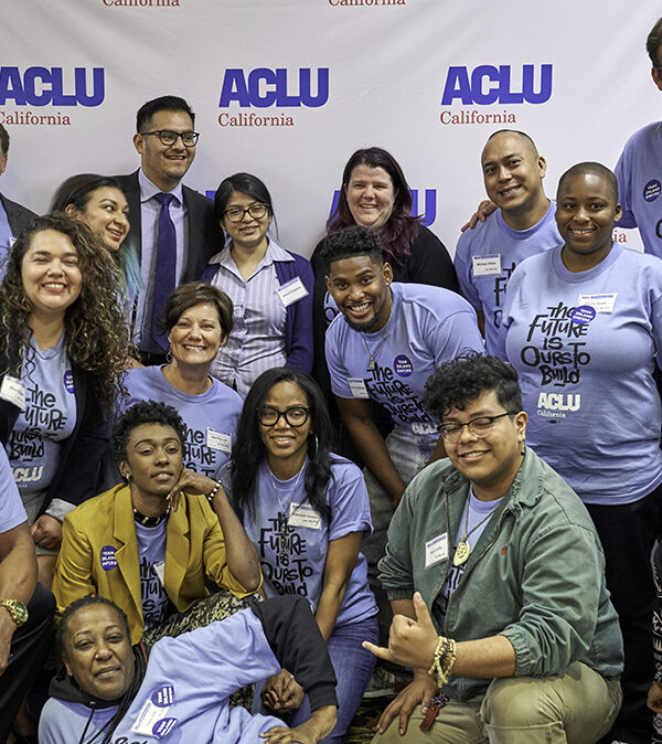A group of people at ACLU CA's 2018 Conference and Lobby Day posing in front of an ACLU backdrop