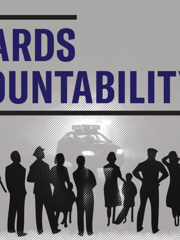 silhouette of people, including police officers in the foreground, a police car with lights in the background