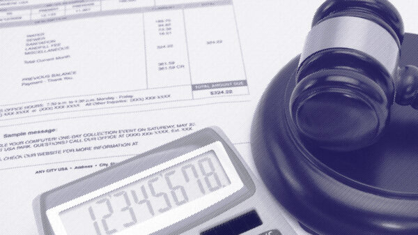 A gavel next to a bill and a calculator