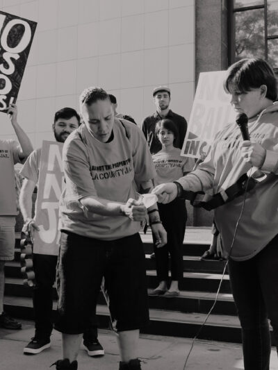 People setting fire to a bill at a protest against criminal system fees
