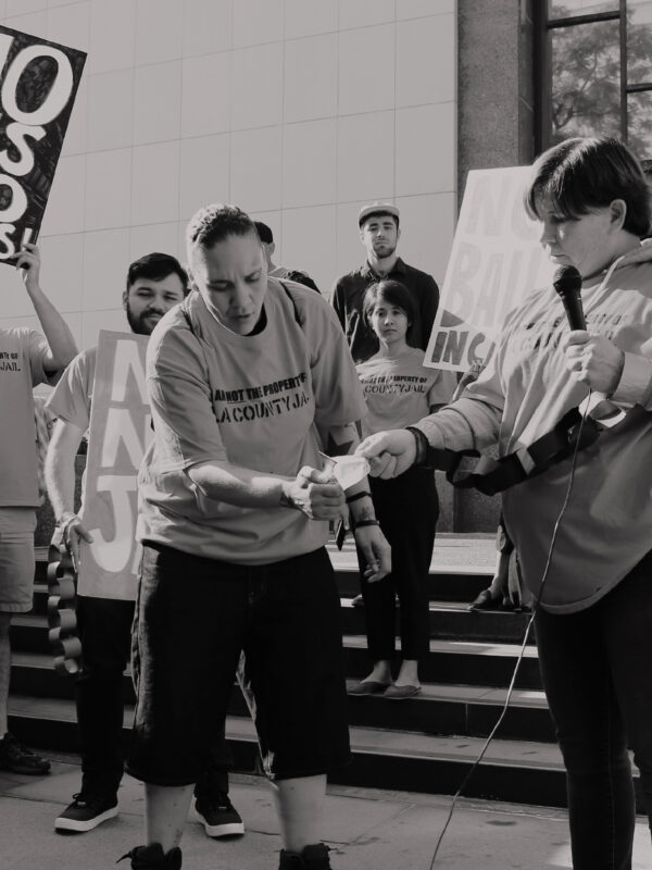 People setting fire to a bill at a protest against criminal system fees