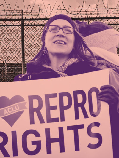 A woman at a protest holding a sign that reads 'I heart repro rights'