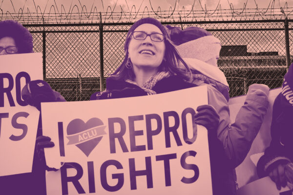 A woman at a protest holding a sign that reads 'I heart repro rights'