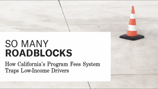 an orange traffic cone on a paved street