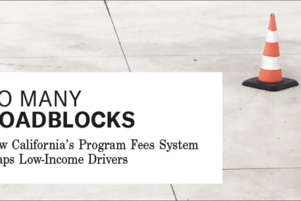 an orange traffic cone on a paved street