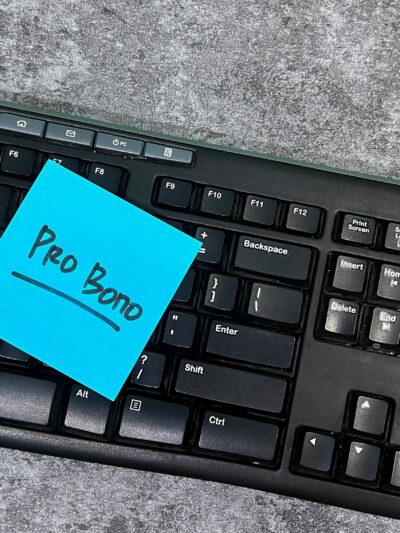 Image of keyboard with blue note with text that reads "Pro Bono"