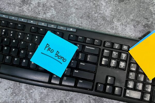 Image of keyboard with blue note with text that reads "Pro Bono"