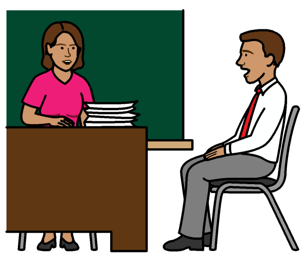 A woman sitting behind a desk talking to a man sitting in a chair beside the desk