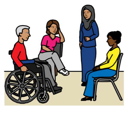 People speaking at a meeting: a person in a wheelchair, a woman sitting in a chair, a woman wearing hijab standing up, and another woman sitting in a chair