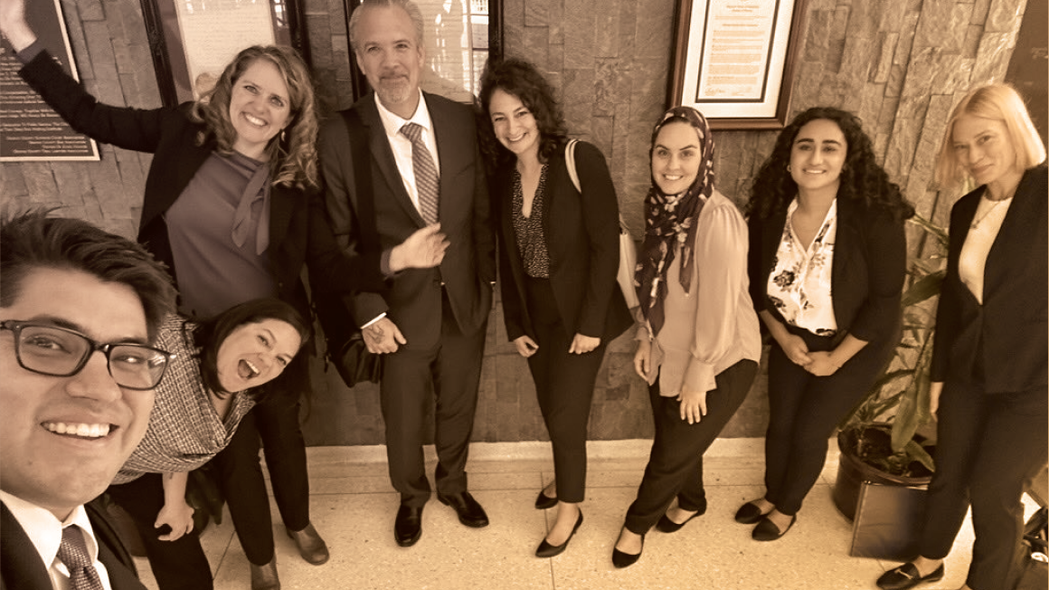 Attorneys and advocates celebrate outside an Orange County courtroom