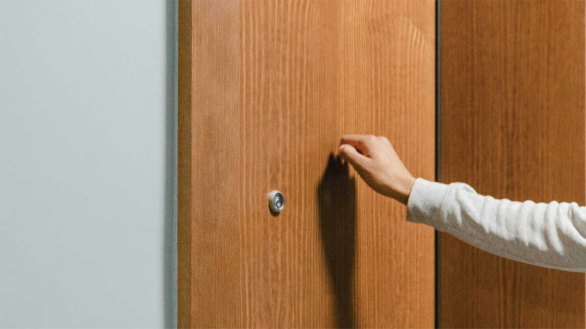 Hand knocking on door