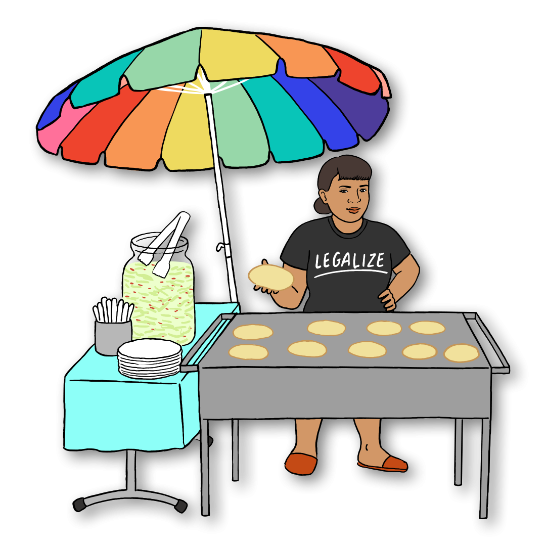 Street vendor sells pupusas under a rainbow umbrella