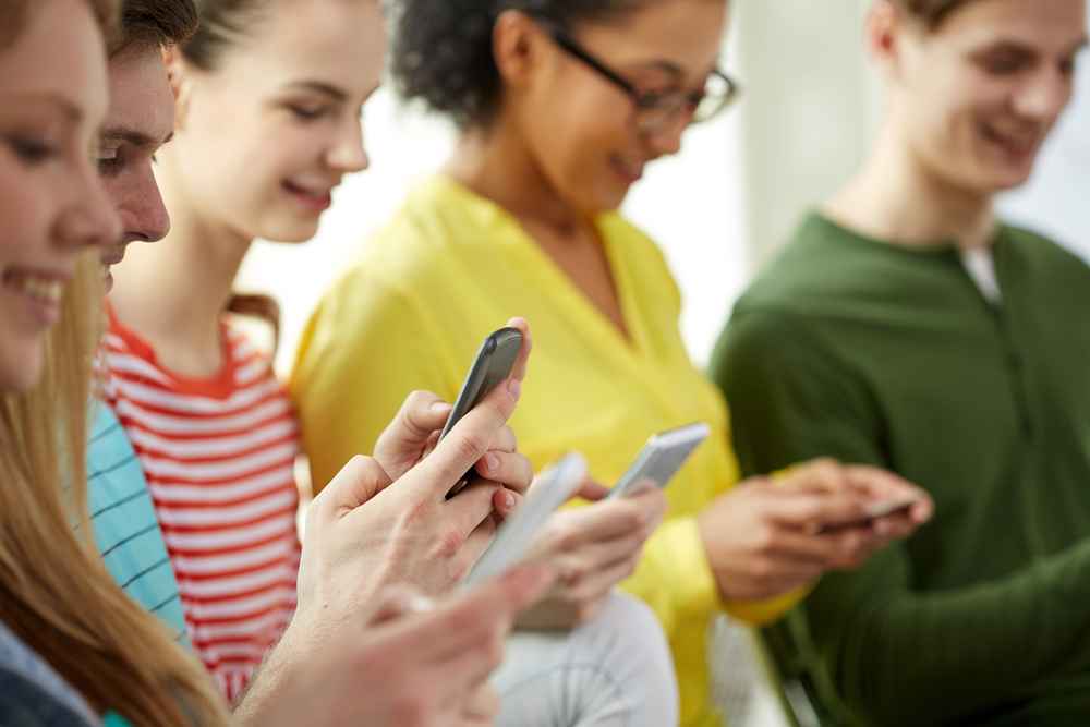 young people looking at their mobile devices