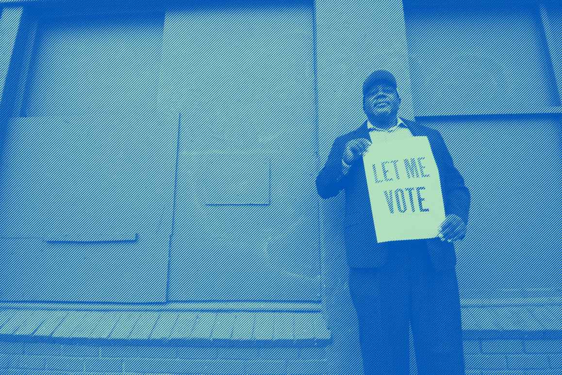 A man holding a sign that reads: "Let Me Vote." Photo credit: Dorsey Nunn by Gigi Pandian, Let Me Vote Aug. 2014