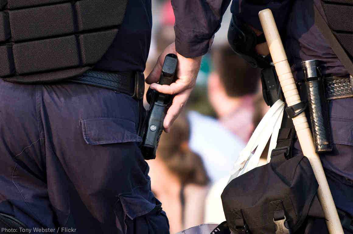 Police officer with his hand on his holstered gun