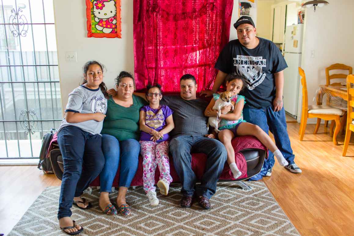 Jesus Arreola with his family sitting on a couch