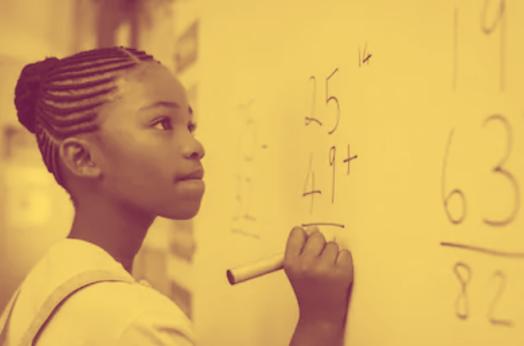 A young Black girl holding a marker, doing arithmetic at a white board