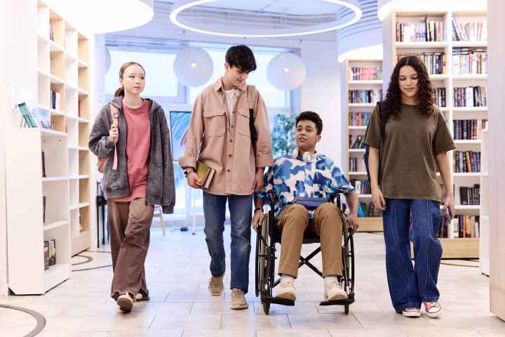 Teenagers walking in library