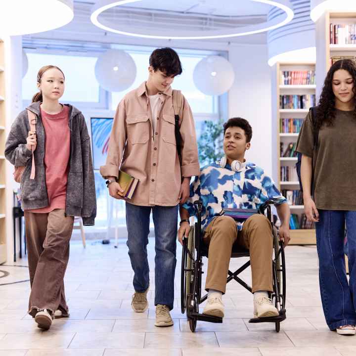 Teenagers walking in library