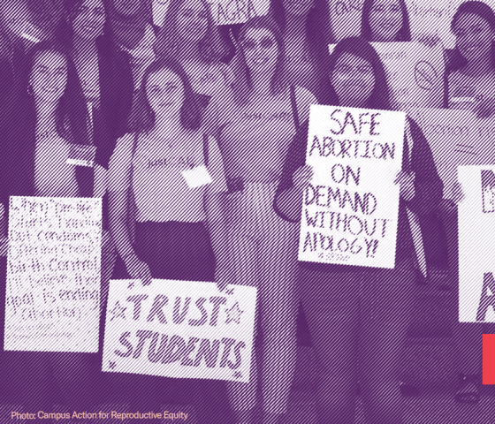 Group of young women holding signs in support of abortion rights such as "Safe abortion on demand without apology" and "Never again" with an illustration of a wire hanger