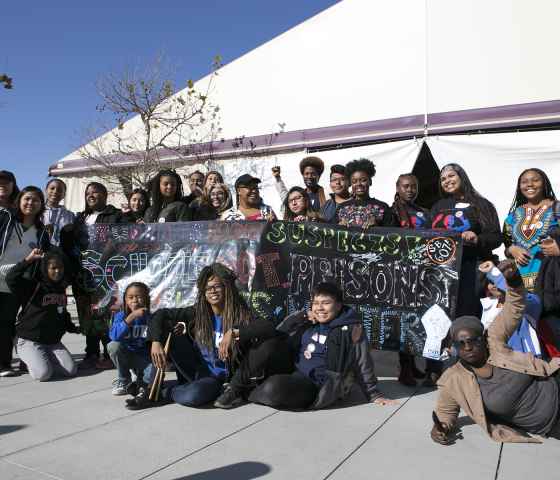 LAUSD student activists gathering around a banner that reads: Students Not Suspects